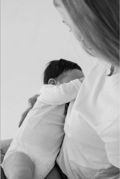 Mother breastfeeding newborn baby skin to skin